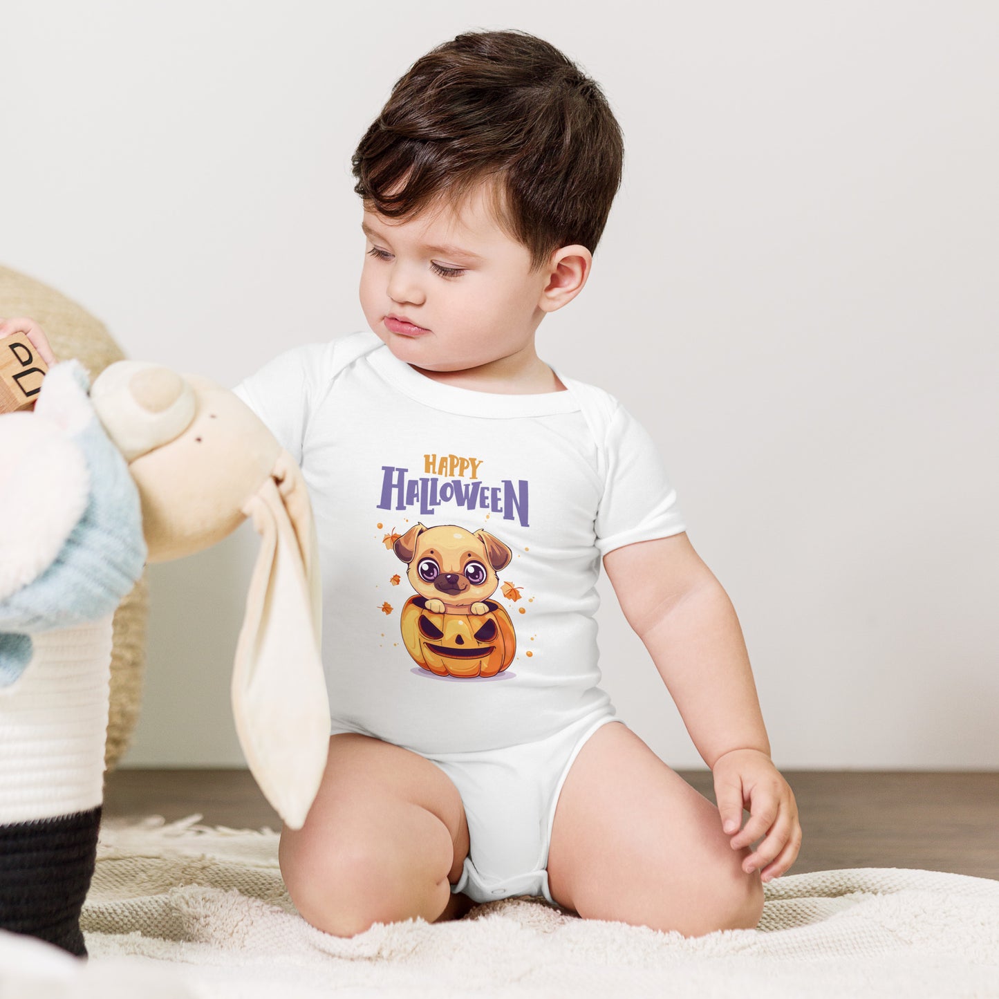 Baby in a white Baby Halloween Bodysuit Animal Design with a cute cartoon pumpkin bear