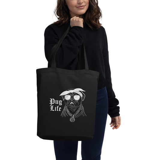 Black reusable tote bag with cute pug shopping bag design and Pug Life print worn by woman