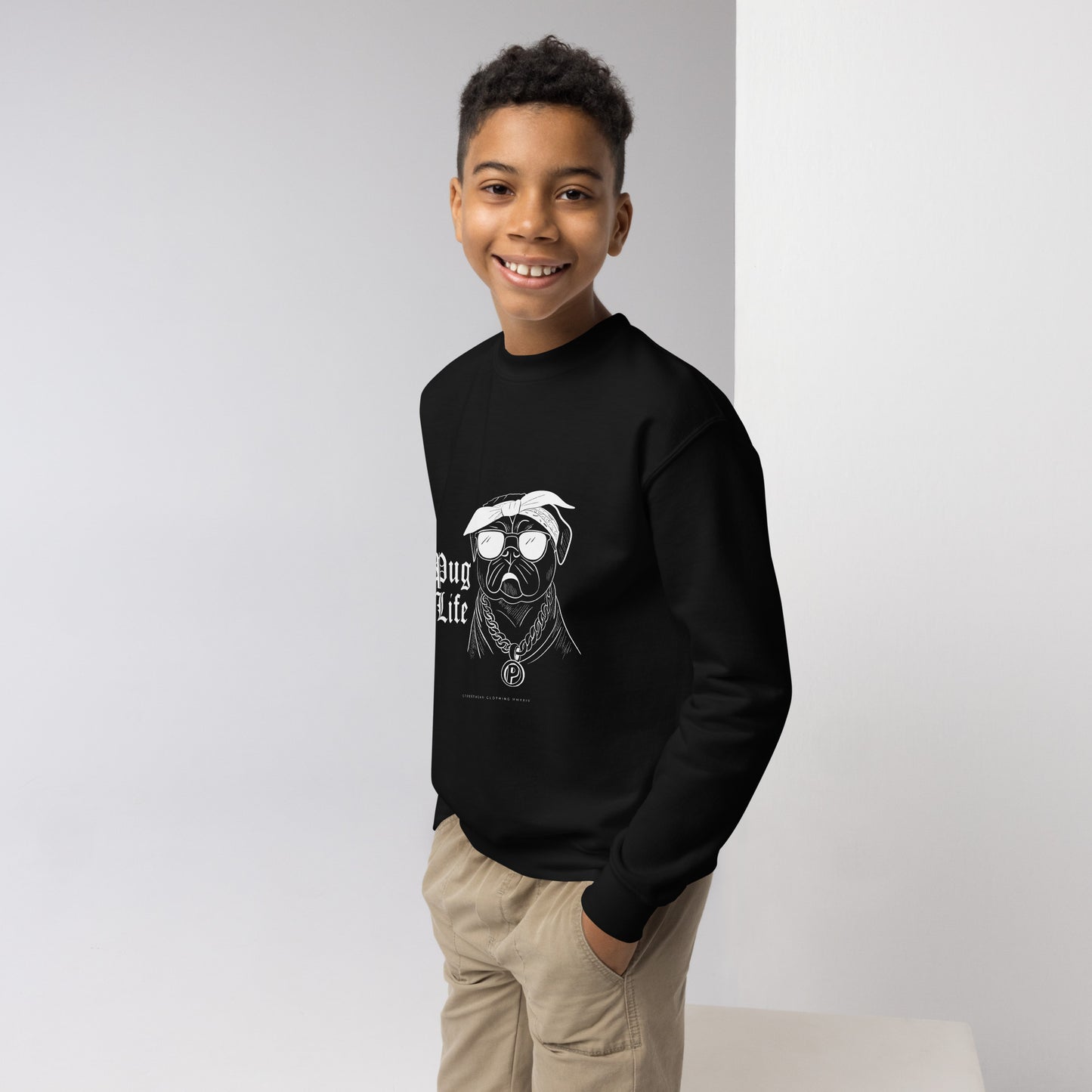 Boy wearing black kids pug themed clothing T-shirt with cool pug graphic and text pug life