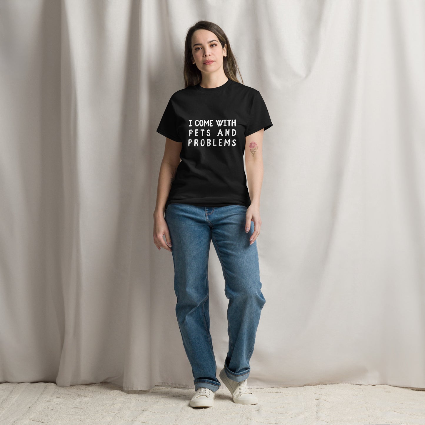 Pet Treasures Studio black T shirt on female model with jeans featuring I come with pets and problems shirt slogan