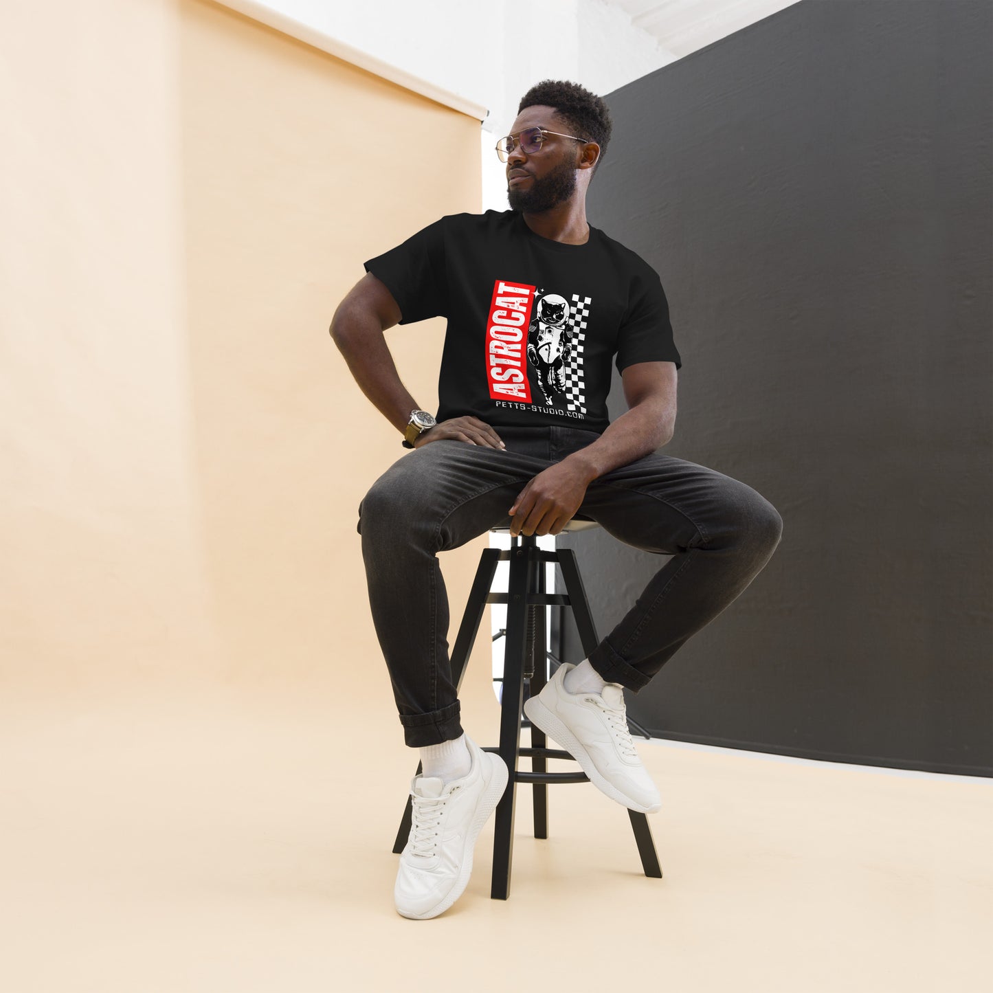 Pet Treasures Studio black cat astronaut graphic tee featuring red vertical text and checkerboard space cat print