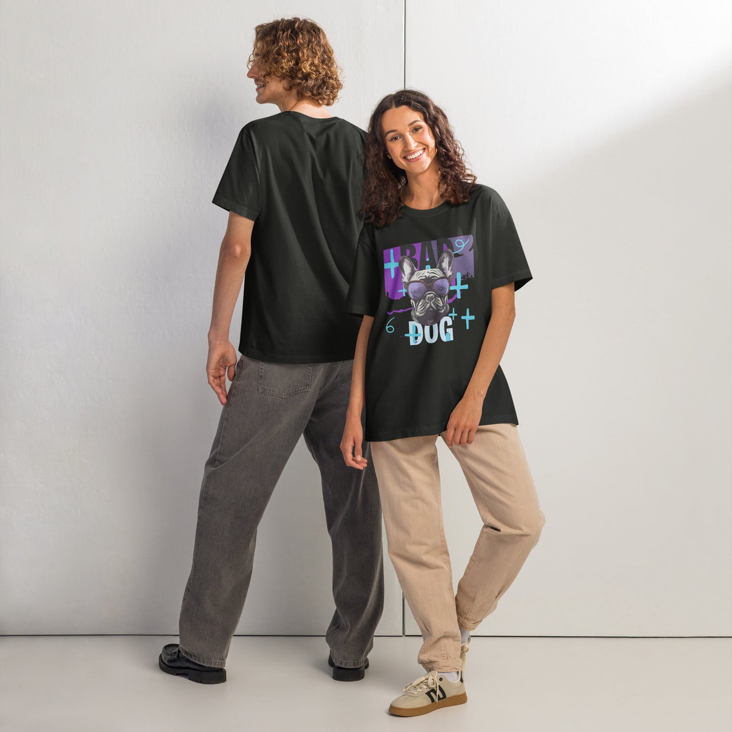 Pet Treasures Studio bad dog t-shirt in black modelled by two people colourful front dog graphic and relaxed unisex fit