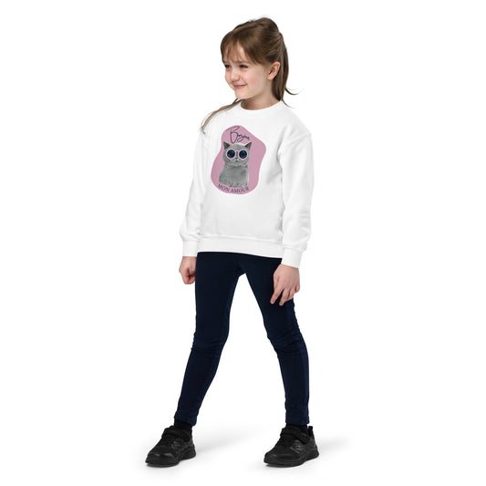 Bonjour Mon Amour crewneck for kids featuring white sweatshirt with cat graphic worn by young girl