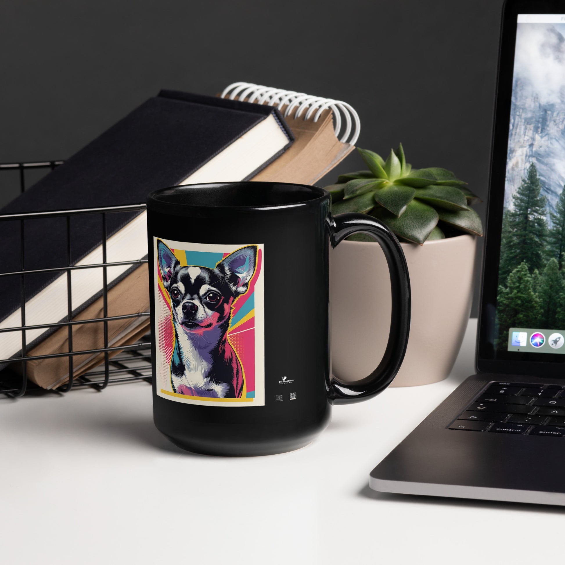 Black cute chihuahua coffee mug with colorful pop art design on a desk near laptop and plant