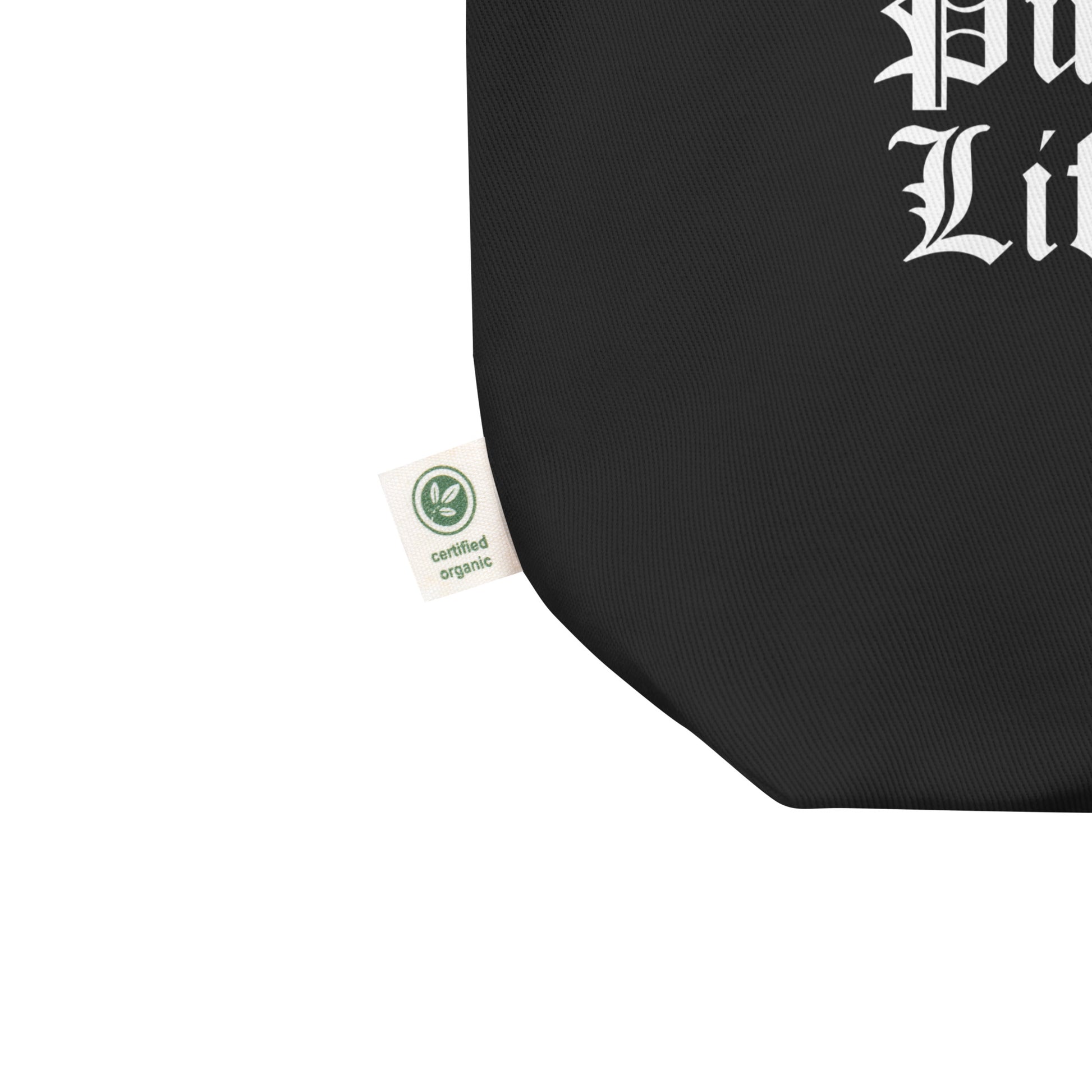 Corner detail of a black reusable cute pug shopping bag with certified organic tag