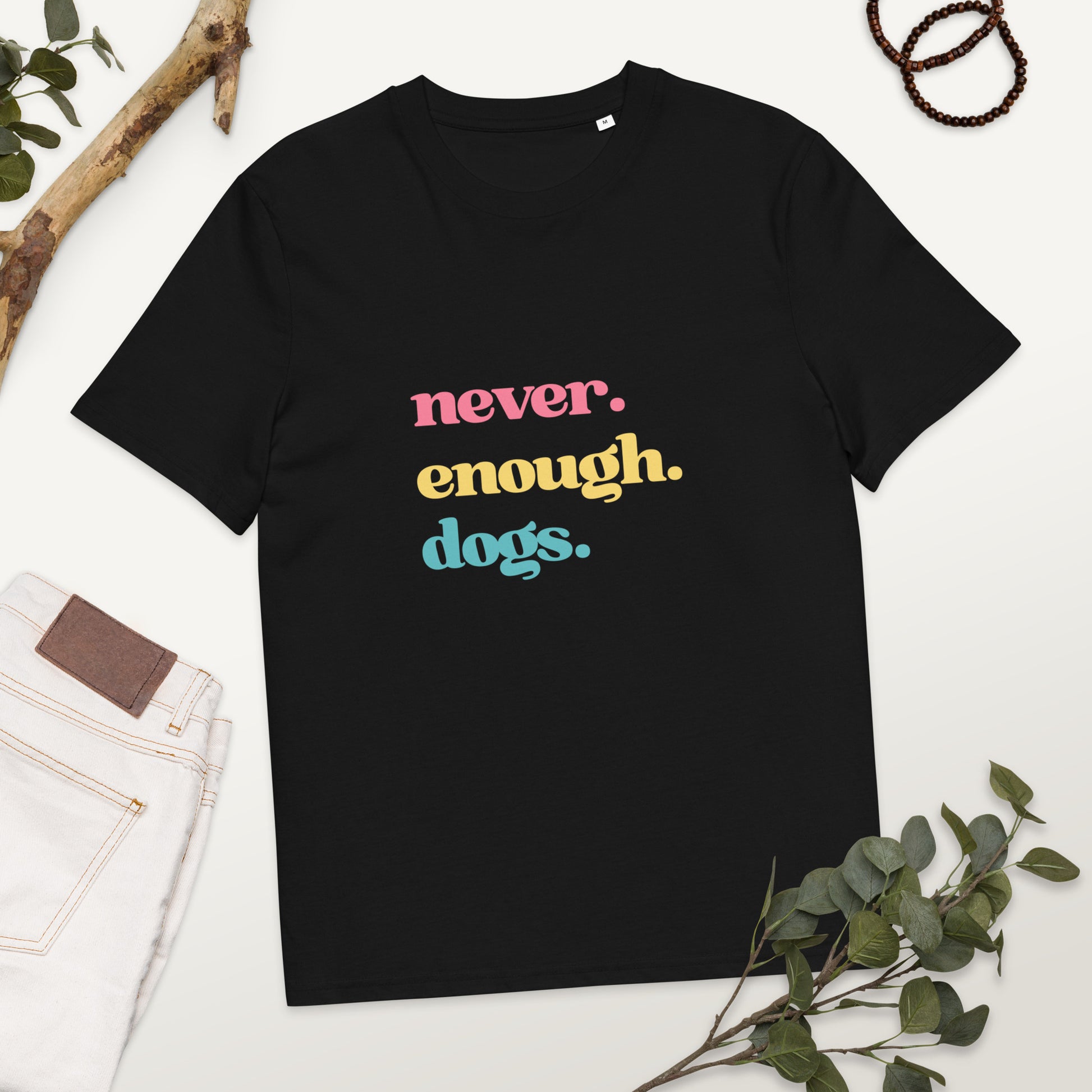 Pet Treasures Studio black cotton t shirt with colourful never enough dogs shirt slogan laid flat with jeans and greenery