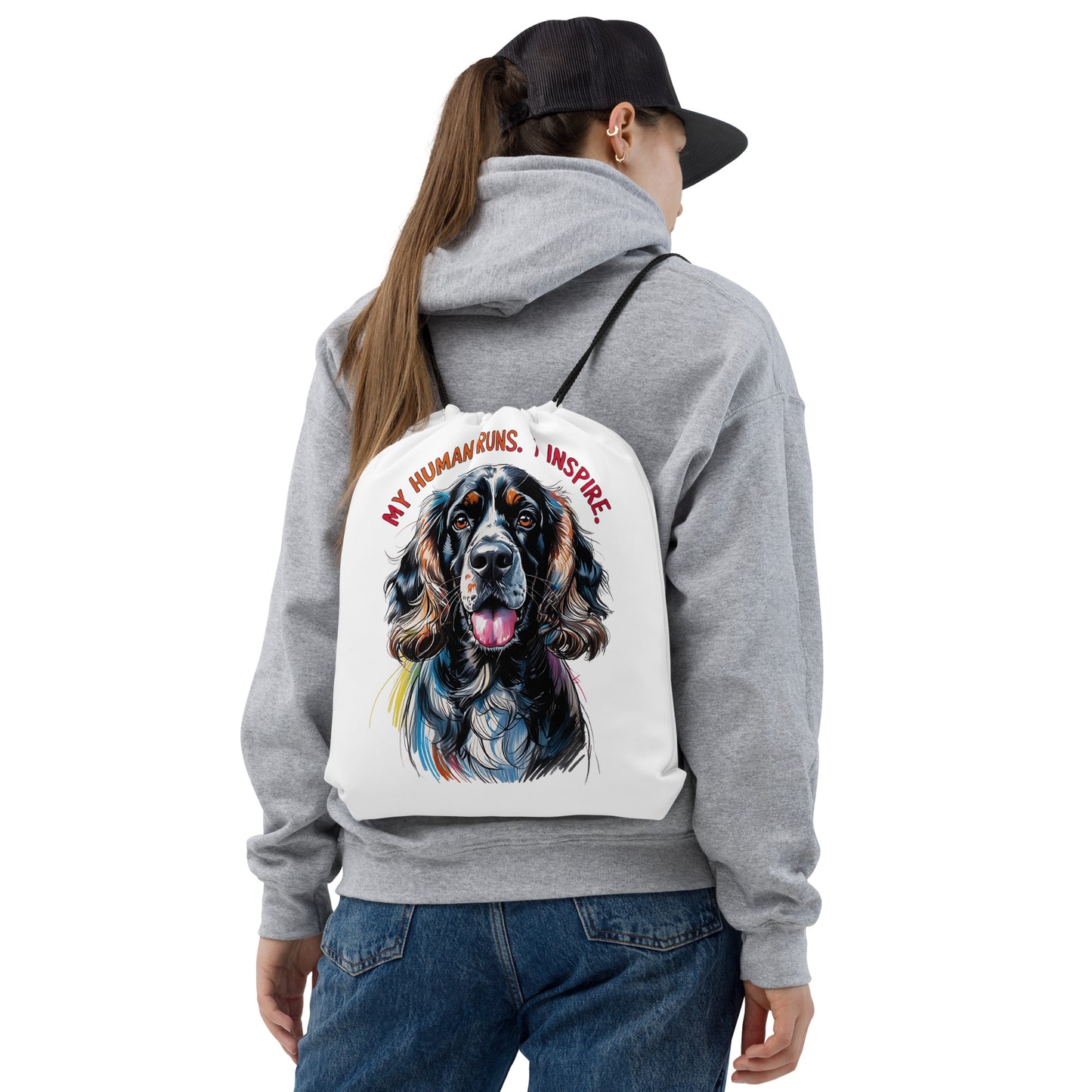 White cocker spaniel sports bag with colorful dog illustration worn by person in gray hoodie