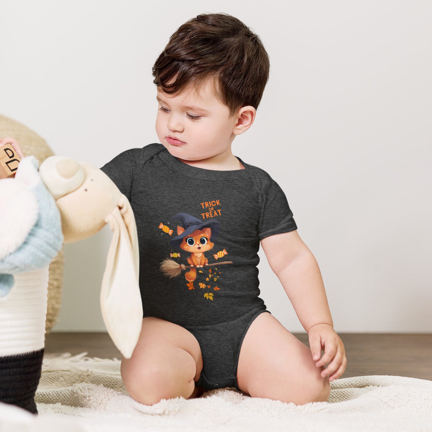 Adorable child wearing a Trick or Treat Baby Bodysuit Animal Design with a witchy animal graphic
