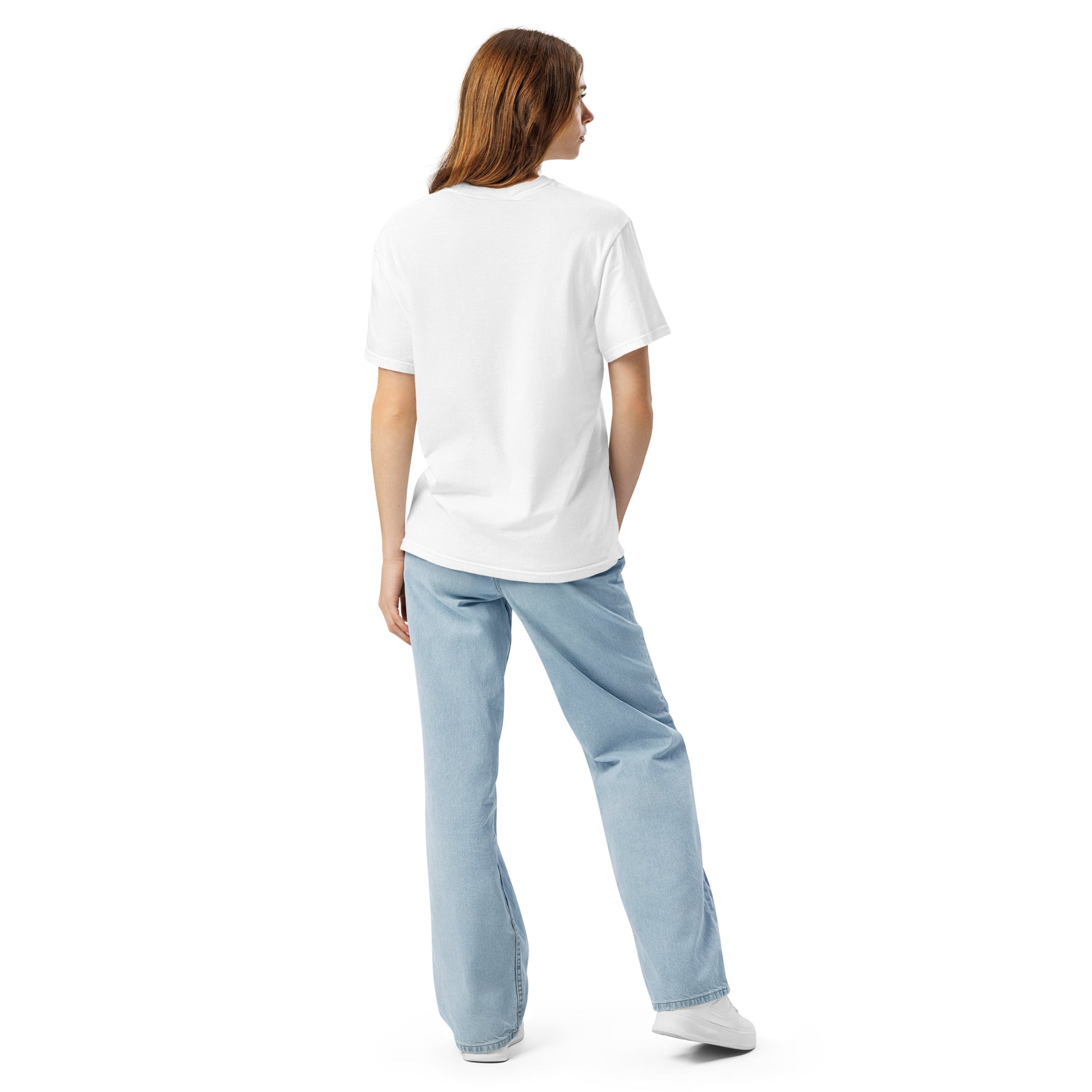 Back view of woman wearing white chihuahua graphic t-shirt with light blue jeans and white shoes